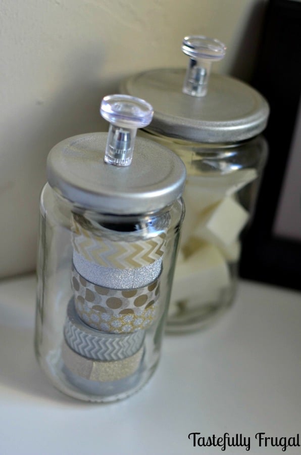 March Pinterest Challenge: DIY Storage Jars for less than $1. All you need are empty glass jars, IKEA Skatta Knobs and Spray Paint.