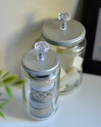 March Pinterest Challenge: DIY Storage Jars for less than $1. All you need are empty glass jars, IKEA Skatta Knobs and Spray Paint.